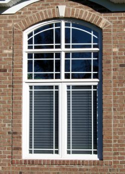 Legacy Twin Casement Window with prairie grids and twin arched transoms.