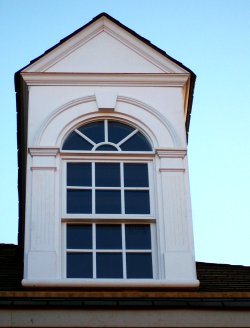Legacy Double Hung Window with half round direct set window, fluted pilasters, and keyed arch.